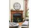 Elegant fireplace with wooden mantle and Roman numeral clock creates a cozy living space at 2130 Monhegan Se Way # 11, Smyrna, GA 30080