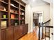 Hallway landing featuring dark wood shelving with display space leading to bedroom at 2130 Monhegan Se Way # 11, Smyrna, GA 30080