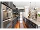 Gourmet kitchen featuring dark cabinets, granite countertops, and stainless steel appliances, ready for chefs at 2130 Monhegan Se Way # 11, Smyrna, GA 30080