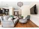 Open-concept living room flows to the kitchen and dining area with wood flooring and neutral tones at 2130 Monhegan Se Way # 11, Smyrna, GA 30080