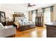 Primary bedroom with wooden furniture, hardwood flooring and blue decorative curtains at 2130 Monhegan Se Way # 11, Smyrna, GA 30080