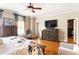 Comfortable main bedroom featuring wood floors, TV, accent furniture, and walk-in closet at 2130 Monhegan Se Way # 11, Smyrna, GA 30080
