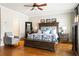 Comfortable main bedroom boasts a ceiling fan, wood floors, chair, and decorative furniture at 2130 Monhegan Se Way # 11, Smyrna, GA 30080