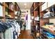Custom walk-in closet with wood shelving, hanging rods, and room for accessories at 2130 Monhegan Se Way # 11, Smyrna, GA 30080