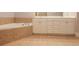Bathroom showing a large tub with ceramic tile surround and double sink vanity at 2382 Gallard St, Lawrenceville, GA 30043