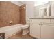 Well-lit bathroom featuring a single vanity, bathtub with shower, and ceramic tile flooring at 2382 Gallard St, Lawrenceville, GA 30043
