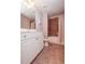 Bathroom with brown tile and white vanity and cabinets at 2382 Gallard St, Lawrenceville, GA 30043