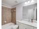 Bathroom features a shower with tiled walls, a large mirror, and a white vanity at 2382 Gallard St, Lawrenceville, GA 30043