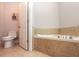 Bathroom featuring a bathtub with ceramic tile surround and a toilet at 2382 Gallard St, Lawrenceville, GA 30043