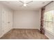 Bedroom offers standard closet, neutral paint and plush carpet with floral curtains at 2382 Gallard St, Lawrenceville, GA 30043