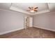 Bedroom with tray ceiling, carpet flooring and ensuite bathroom access at 2382 Gallard St, Lawrenceville, GA 30043