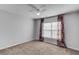 Bedroom with carpeted floors, fan, and window with decorative curtains at 2382 Gallard St, Lawrenceville, GA 30043