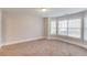 Bedroom with a large window, neutral walls, and carpet at 2382 Gallard St, Lawrenceville, GA 30043