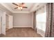 Bedroom with tray ceiling, carpet flooring, windows with curtains and ensuite access at 2382 Gallard St, Lawrenceville, GA 30043