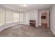 Bedroom features window with blinds, neutral paint, carpet, and hall and en suite access at 2382 Gallard St, Lawrenceville, GA 30043