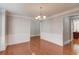 Dining room featuring hardwood floors, wainscoting detail, and a modern light fixture at 2382 Gallard St, Lawrenceville, GA 30043