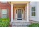 Inviting entryway featuring a brick porch, white columns, and a stylish front door with sidelights at 2382 Gallard St, Lawrenceville, GA 30043