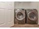 Laundry room features a side-by-side Samsung washer and dryer and wire shelving at 2382 Gallard St, Lawrenceville, GA 30043