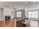 Bright living area features hardwood floors, a cozy fireplace, and a kitchen island with granite countertops at 2382 Gallard St, Lawrenceville, GA 30043