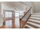Open concept living area with hardwood floors, fireplace, and access to staircase at 2382 Gallard St, Lawrenceville, GA 30043