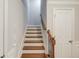 Staircase with wooden steps and railings, and a white door at the bottom at 2382 Gallard St, Lawrenceville, GA 30043