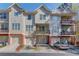 Charming townhome exterior featuring a private balcony, attached garage, and well-maintained landscaping at 2382 Gallard St, Lawrenceville, GA 30043