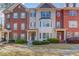 Stunning townhome exterior featuring brick facade, shuttered windows, and neatly manicured landscaping at 2382 Gallard St, Lawrenceville, GA 30043