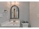 Well-lit bathroom with a large mirror, white sink, and modern fixtures for a clean and functional space at 3006 Cambridge Hill Dr, Dacula, GA 30019