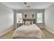 Bright bedroom with a tufted headboard, two windows, and neutral carpet at 3006 Cambridge Hill Dr, Dacula, GA 30019