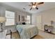 Comfortable bedroom featuring a ceiling fan, two windows, and neutral decor at 3006 Cambridge Hill Dr, Dacula, GA 30019