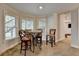 Bright breakfast nook featuring three windows and barstool seating area with table at 3006 Cambridge Hill Dr, Dacula, GA 30019