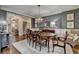 Formal dining room with a large oval table, chandelier, and a decorative area rug at 3006 Cambridge Hill Dr, Dacula, GA 30019