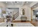 Bright foyer features hardwood floors, staircase, and elegant decor at 3006 Cambridge Hill Dr, Dacula, GA 30019