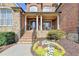 Inviting porch with stone stairs, black railings, and elegant flower bed in front at 3006 Cambridge Hill Dr, Dacula, GA 30019