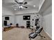 Well-equipped home gym featuring workout equipment, TV, mirror and fan at 3006 Cambridge Hill Dr, Dacula, GA 30019