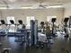 A gym with multiple treadmills, weight machines, ceiling fans, and windows offering natural light and ventilation at 3006 Cambridge Hill Dr, Dacula, GA 30019