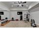 Well-equipped home gym featuring workout equipment, TV, mirror and fan at 3006 Cambridge Hill Dr, Dacula, GA 30019