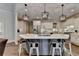 Spacious kitchen featuring a large center island with seating and modern pendant lighting at 3006 Cambridge Hill Dr, Dacula, GA 30019
