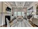 Bright living room with hardwood floors, a coffered ceiling, and a cozy fireplace at 3006 Cambridge Hill Dr, Dacula, GA 30019