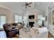 Bright living room featuring a fireplace, plush seating, and a high vaulted ceiling with fan at 3006 Cambridge Hill Dr, Dacula, GA 30019