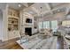 Elegant living room boasts custom built-ins, fireplace, and hardwood floors at 3006 Cambridge Hill Dr, Dacula, GA 30019