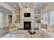 Inviting living room showcasing a fireplace, built-in shelving, and cozy seating area at 3006 Cambridge Hill Dr, Dacula, GA 30019