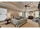 Spacious main bedroom with a tray ceiling, ceiling fan, and serene decor with large windows at 3006 Cambridge Hill Dr, Dacula, GA 30019