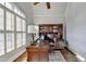 Cozy office space with hardwood floors, large window and traditional wooden desk and shelving at 3006 Cambridge Hill Dr, Dacula, GA 30019