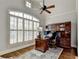 Bright office space with large window, hardwood floors, and built-in shelving for storage and organization at 3006 Cambridge Hill Dr, Dacula, GA 30019