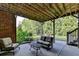 Covered outdoor patio area featuring furniture and view of backyard landscaping at 3006 Cambridge Hill Dr, Dacula, GA 30019