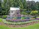 Hamilton Mill water wheel surrounded by beautiful landscaping at 3006 Cambridge Hill Dr, Dacula, GA 30019