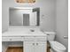 Bathroom featuring a large vanity with white cabinets and a toilet with wood-look flooring at 735 Crestwell Sw Cir, Atlanta, GA 30331