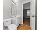 Bathroom view with a toilet, vanity, and a doorway to another room at 735 Crestwell Sw Cir, Atlanta, GA 30331