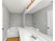 Well-lit bathroom featuring a modern vanity, large mirror, and a relaxing soaking tub at 735 Crestwell Sw Cir, Atlanta, GA 30331